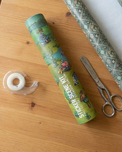 Sticker kit tube and tools on a wooden table